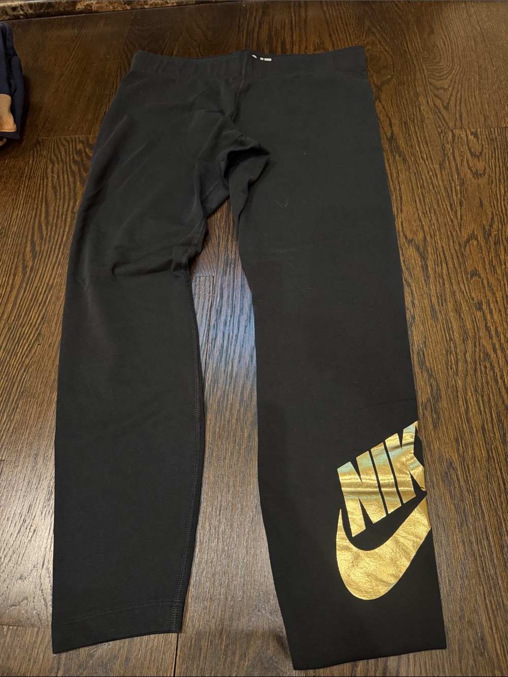 Nike womans Black Leggings with Gold Logo Accent